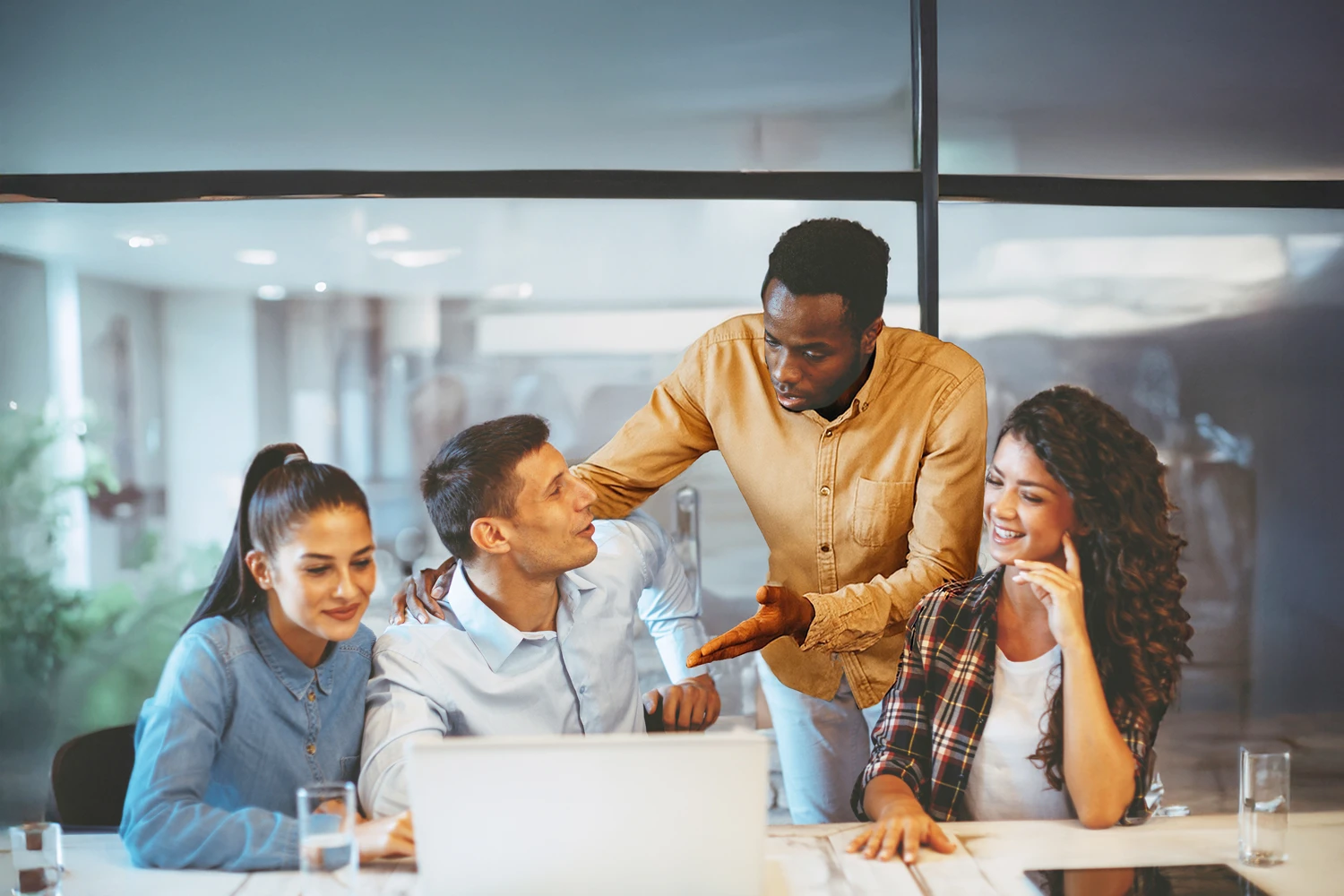 Team of colleagues collaborating and discussing in a casual office setting