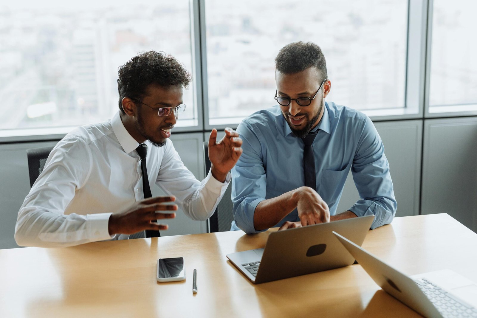 Small business owners reviewing bookkeeping records together on a laptop