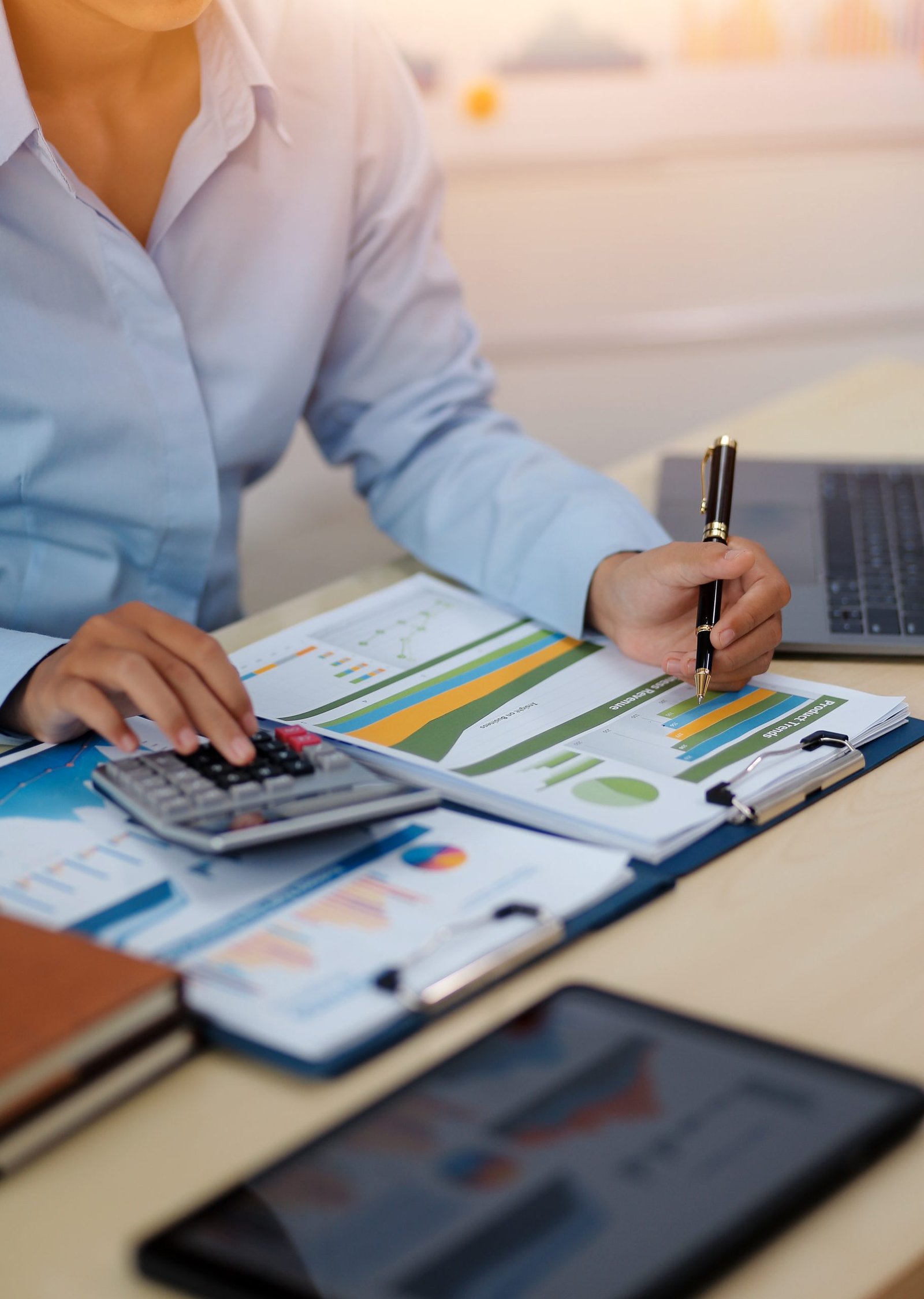 "Small business owner checking the NDIS price guide against current invoice rates"