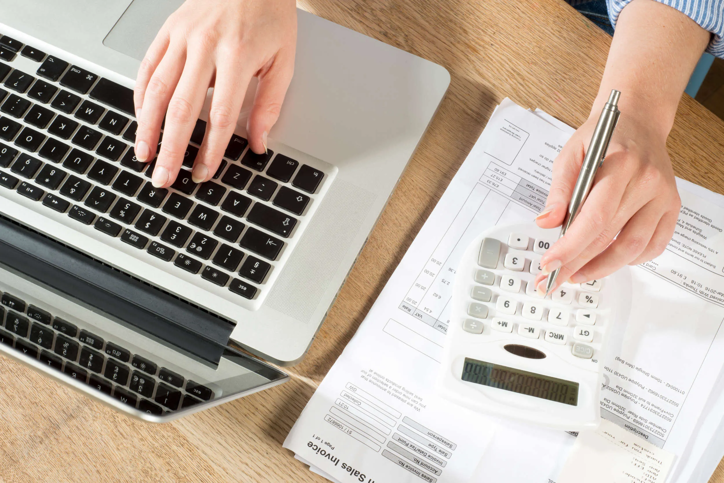 "Tradie reviewing job costing and invoicing figures on a tablet at a work site"
